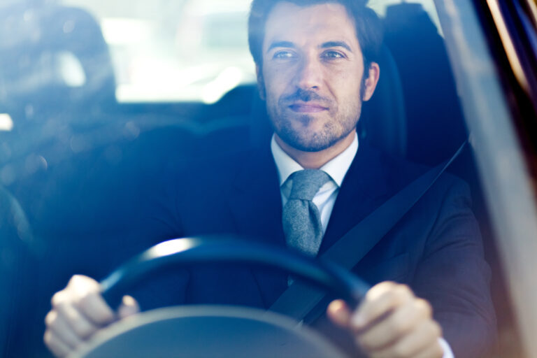 Professional chauffeur at the wheel of a vehicle