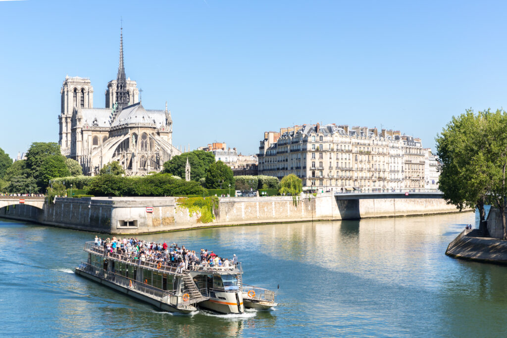 A sightseeing boat on the Seine in front of Notre-Dame Cathedral in Paris.